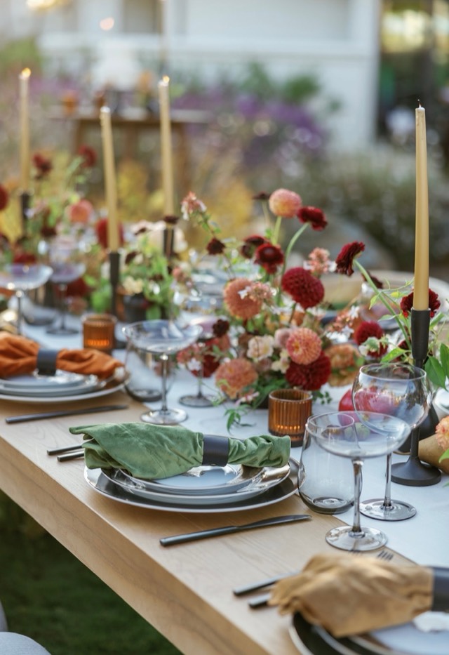 Autumn Romance wedding tablescape — long harvest table with crimson dahlias, gold taper candles, amber votives, and velvet napkins — Lux Events by Michelle