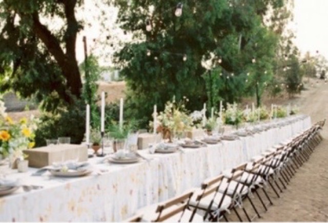Destination wedding reception — long outdoor dining table under eucalyptus trees with taper candles and wildflower arrangements — Lux Events by Michelle