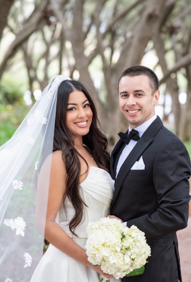 Minimalist luxury wedding portrait — bride in strapless gown with cathedral veil and white hydrangea bouquet, groom in black tuxedo — Lux Events by Michelle