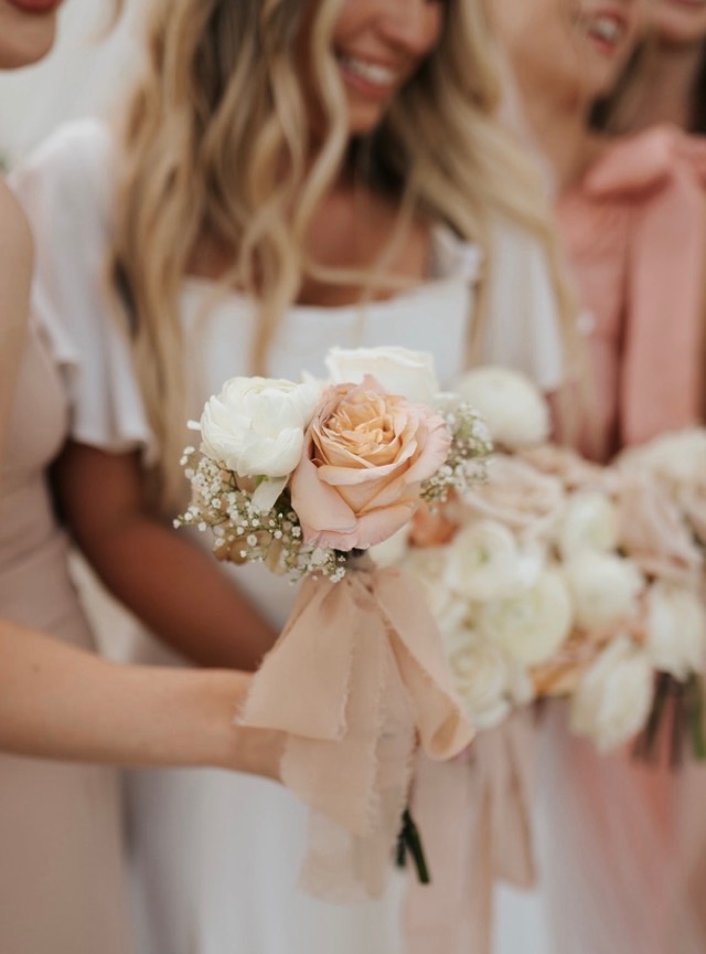 Minimalist luxury wedding florals — bridesmaids holding blush garden roses and ranunculus bouquets tied with champagne ribbon — Lux Events by Michelle